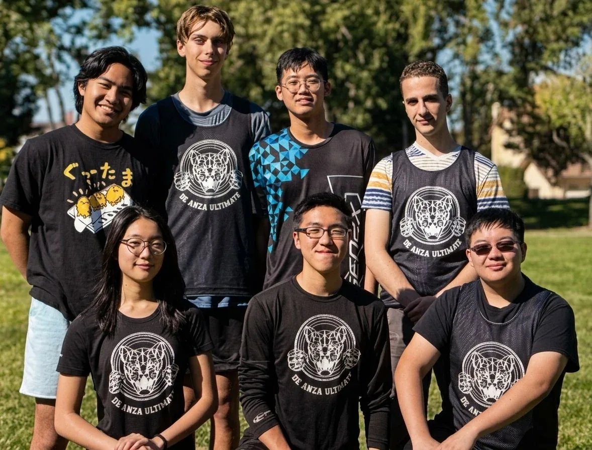 Players in black club shirts printed with a tiger, standing together outdoors